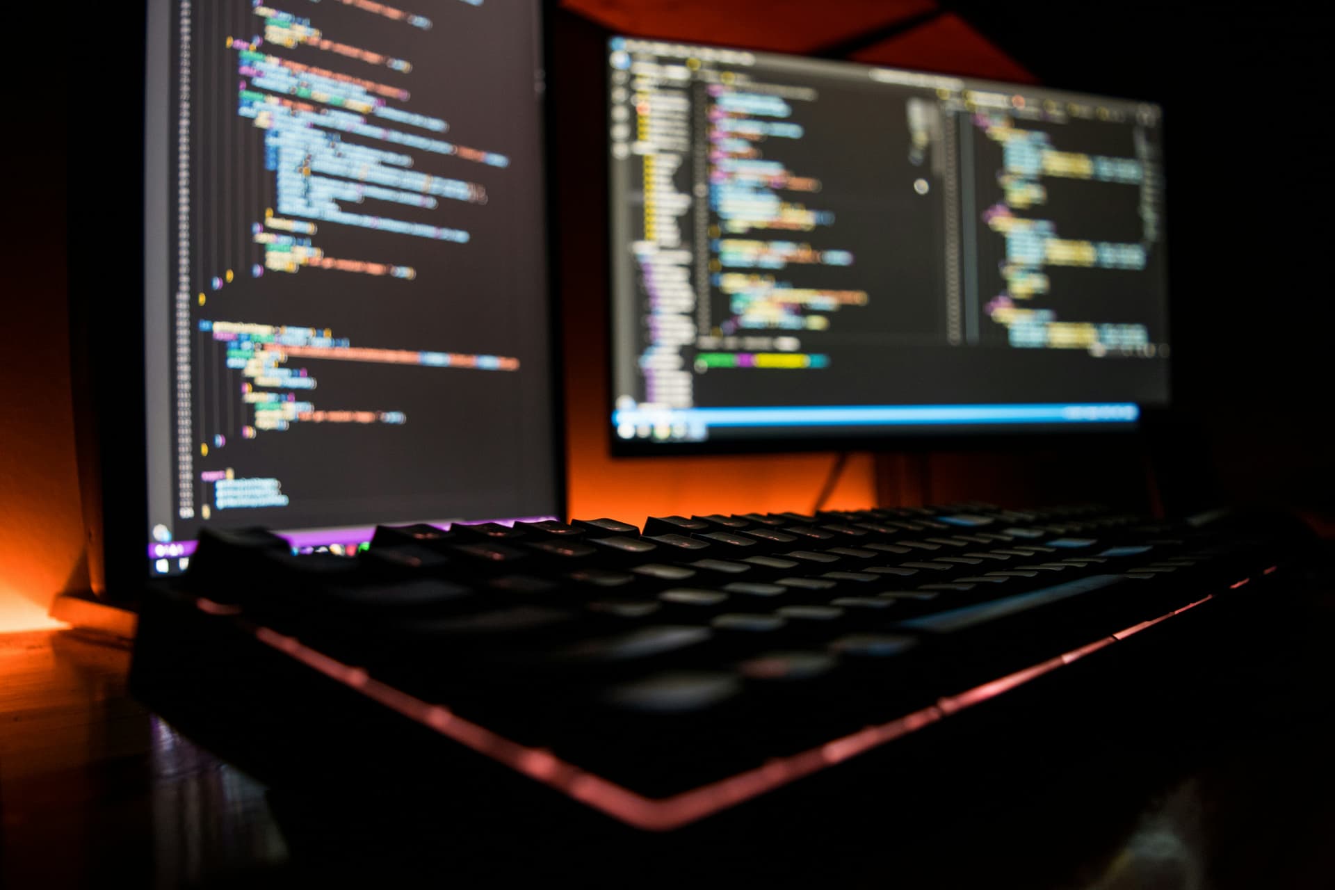 Close-up of hands typing code on laptop